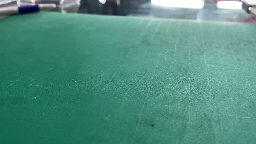 Picking up unidentified starfish shaped on paper close up view from   green cutting mat. Drawing and art concept