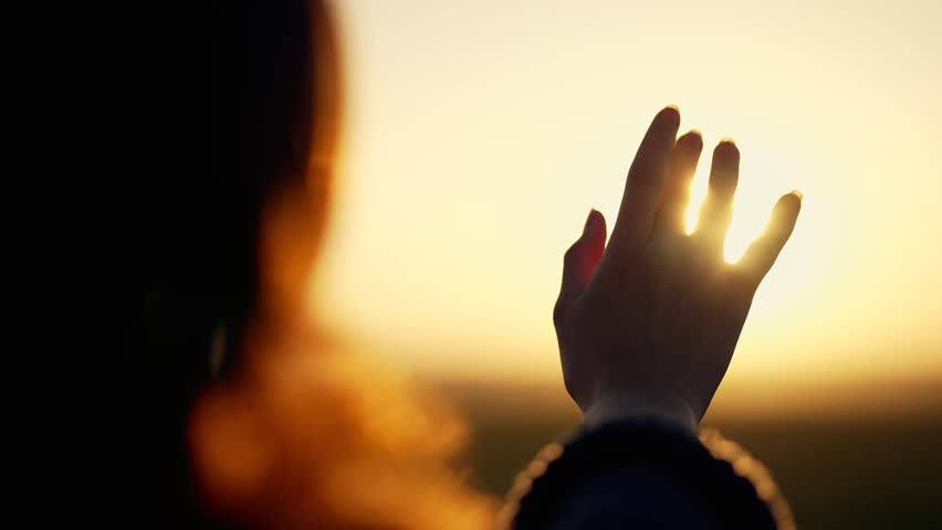 Silhouette of happy dreaming girl pulls her hand to sun.Religion helping hand. Happy girl pulls her hand.Prayer in religion.Silhouette of hand in sun.Happy girl silhouette at sunset.Freedom in nature Royalty-Free Stock Footage #3496885635