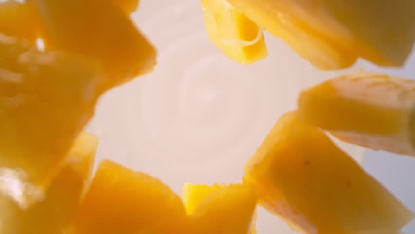Super Slow Motion Shot of Pineapple Cuts Followed by Camera Falling into Yogurt at 1000fps.