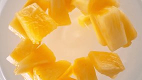 Super Slow Motion Shot of Pineapple Cuts Followed by Camera Falling into Yogurt at 1000fps. - Powered by Shutterstock - Get 15% off with code: PIKWIZARD15