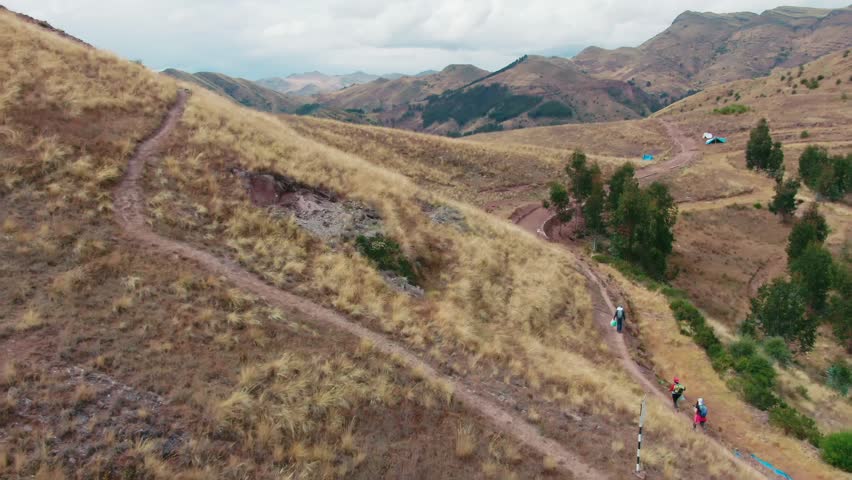 Aerial dolly reveals the ruins of an old Inca trail on the Huancaure trek, birthplace of Cusco, Peru