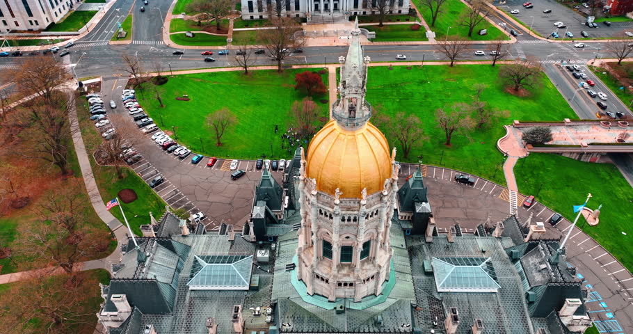 Distancing from the golden cupola of Connecticut State Capitol in Hartford, Connecticut, USA. Aerial view on the beautiful historical building in the urban landscape.