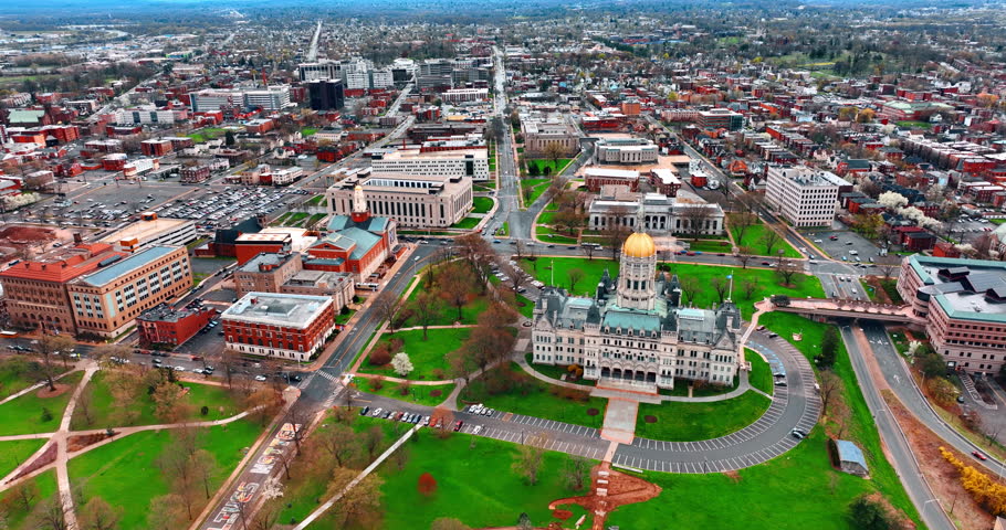 Flying closer to the building of Connecticut State Capitol in Hartford, Connecticut, USA. Daytime view on the city from aerial perspective.