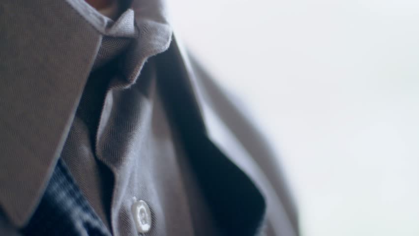 Close-up of hispanic man getting ready tying a necktie in the morning Royalty-Free Stock Footage #34971496