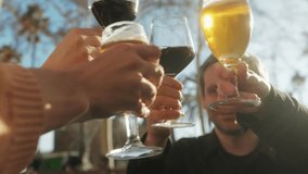 Young men having fun together,celebrating and cheers drinking beer and clinking glasses outdoorclose-up. - Powered by Shutterstock - Get 15% off with code: PIKWIZARD15