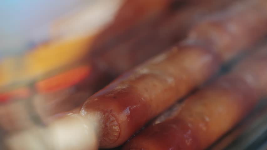 Fried sausage in breadcrumbs on a stick close-up.Cooking corn dogs in boiling oil. Traditional asian corndog snacks street food. Korean Chinese street local market with traditional food. American fast Royalty-Free Stock Footage #3497248939