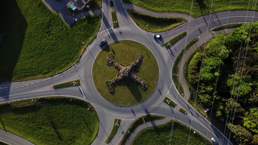 Aerial static view of unique roundabout intersection. Colorful cars.