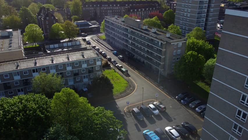 Drone flying over streets and council housing estate in urban London