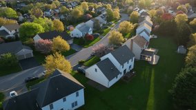 Dramatic light, aerial turn reveals American neighborhood, residential development community during spring season magic hour, Small Town America - Powered by Shutterstock - Get 15% off with code: PIKWIZARD15