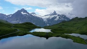 Bachalpsee lake at dawn, Bernese Oberland, Switzerland. Alpine view of the Mt. Schreckhorn and Wetterhorn. Location Bachalpsee in Swiss alps, Grindelwald valley, Interlaken, Europe, Switzerland. - Powered by Shutterstock - Get 15% off with code: PIKWIZARD15