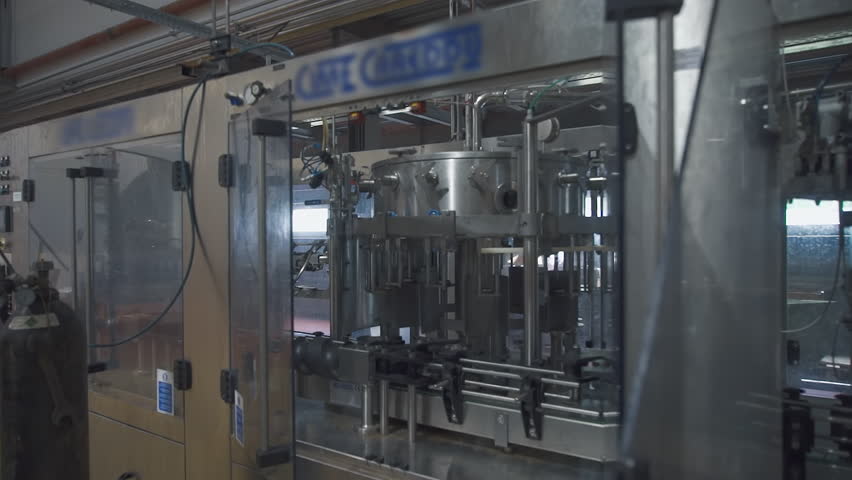 Industrial factory equipment used for production of alcoholic drinks. Modern industrial factory equipment on the production line. Automated industrial factory equipment manufacturing beverages.