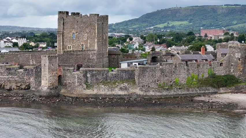 Carrickfergus Castle in County Antrim Northern Ireland. Part of the Causeway Coastal Route. Aerial 50fps UHD