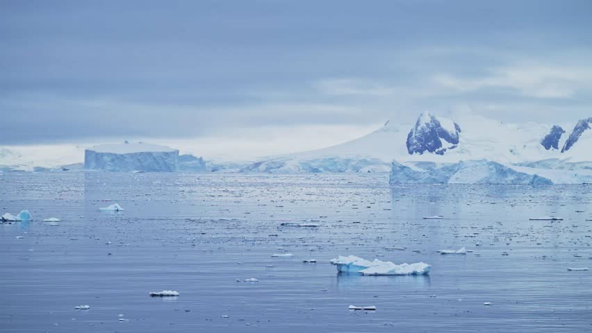 Mountains Iceberg and Winter Sea in Cold Blue Landscape Scenery, Antarctica Seascape with Ice and Glacier in Dramatic Beautiful Coastal Scene on Coast on Antarctic Peninsula, Moody Blue Atmosphric