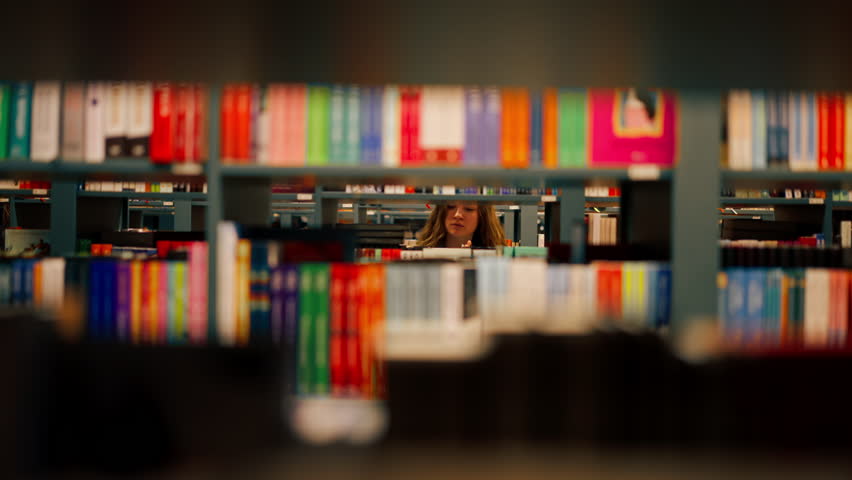 close up in a bookstore young girl chooses a new book for herself preparing for exams