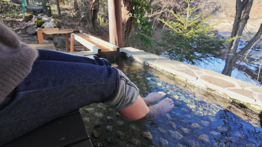 A woman taking a footbath at a hot spring resort