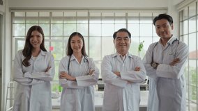 Successful team of asian medical doctors in uniform standing with arms crossed, smiling to camera in hospital. Professional of asian doctors. Confidence teamwork - Powered by Shutterstock - Get 15% off with code: PIKWIZARD15