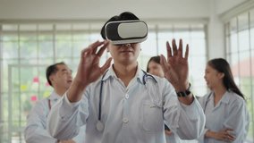 Young asian doctor in white lab coat with stethoscope wearing futuristic VR technology glasses with medical digital, touching on the air while working at hospital. Future medical innovations - Powered by Shutterstock - Get 15% off with code: PIKWIZARD15