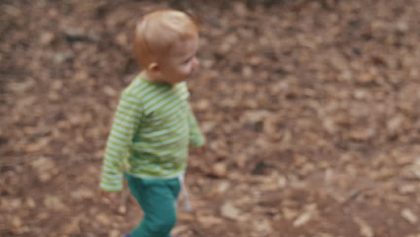 a baby boy playing in the park