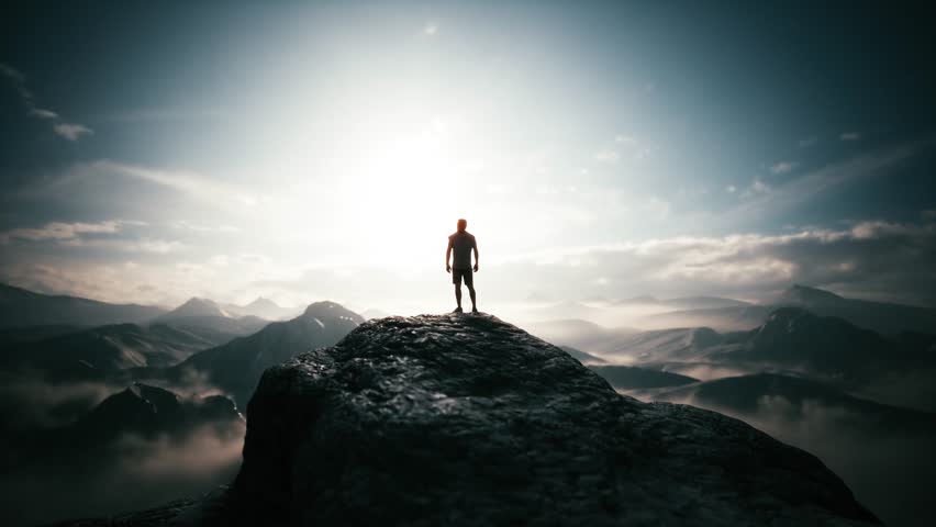 Young man standing on top of mountain. The concept of achieving success