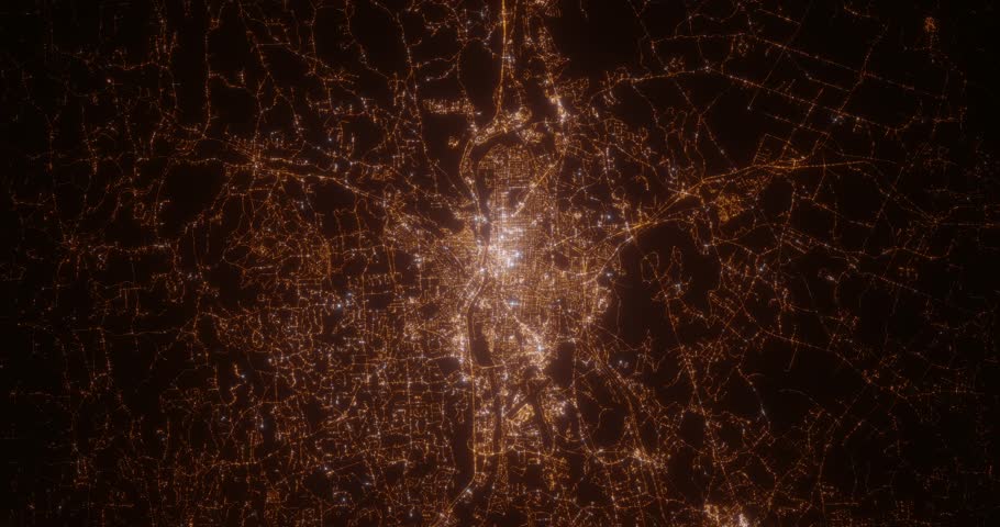 Manchester (New Hampshire, USA) aerial view at night. Top view on city from space. Camera is zooming in, rotating clockwise