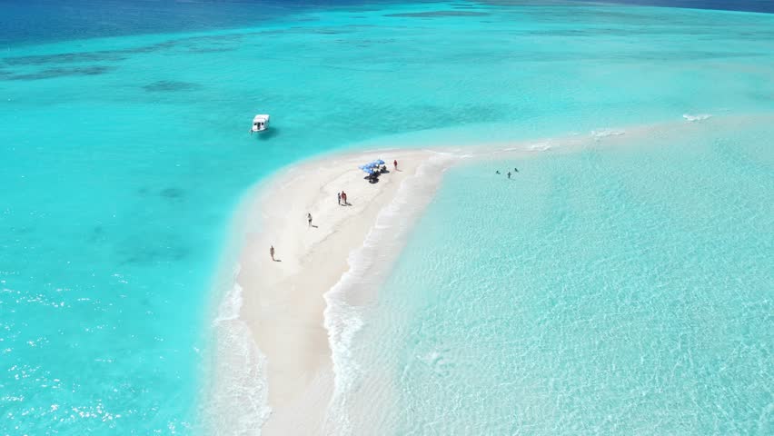 Sandbank and transparent blue sea with waves. Aerial view seascape in Maldives