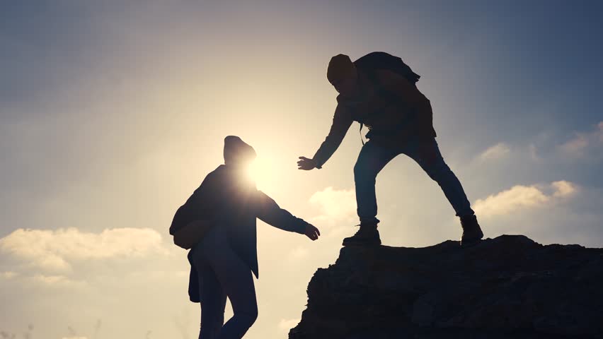 business. teamwork helps hand down business silhouette concept. a group of tourists lend a helping hand, climbing rocks, mountains, lend helping hand. teamwork people climbers climb to travel top Royalty-Free Stock Footage #3497765057