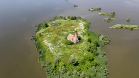 Drone circles the submerged Church of St. Linhart at Mušov Lake, capturing its serene and haunting beauty from above.