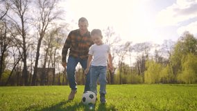 toddler and father playing ball in park. happy family kid dream concept. child playing soccer ball with father in park at sunset. baby plays ball with father lifestyle in the park - Powered by Shutterstock - Get 15% off with code: PIKWIZARD15