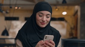Muslim girl Arabian islamic woman in hijab happy female businesswoman business entrepreneur office manager executive using mobile phone typing sms texting message online smartphone chatting smiling - Powered by Shutterstock - Get 15% off with code: PIKWIZARD15