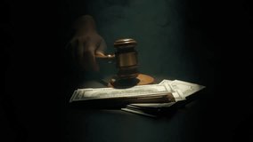 Female at the desk with wooden hammer, dark room bright spotlight and smoke. Woman judge in the court room, hand hitting wooden gavel, money banknotes laying around, close up shot. - Powered by Shutterstock - Get 15% off with code: PIKWIZARD15