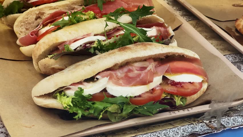 Piadina Italian Flatbread with jamon, lettuce, tomato and cheese. Royalty-Free Stock Footage #3497983785