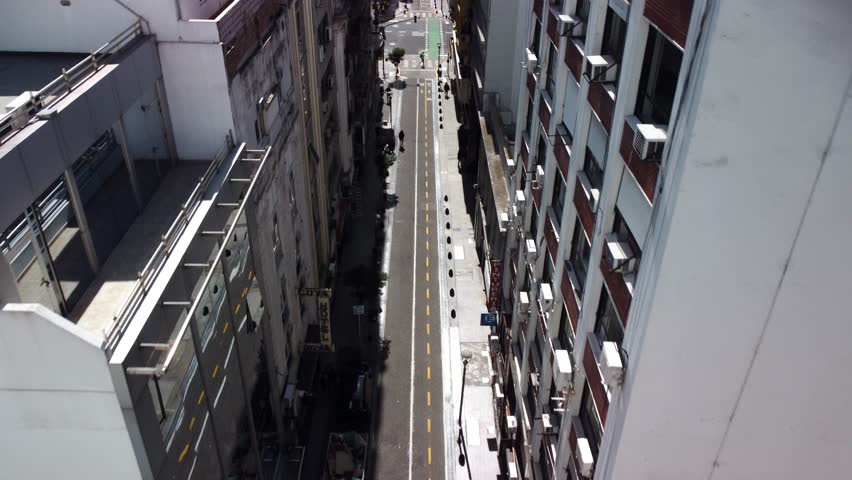 Aerial view of Buenos Aires, Argentina. Top-down drone perspective captures city skyline, urban architecture, street traffic. Modern buildings, residential apartments, downtown landmarks.