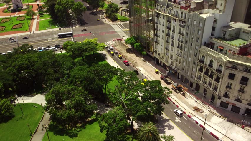 Traffic flows through downtown Buenos Aires, Plaza de Mayo Square. Aerial view of modern cityscape, skyscrapers, and bustling streets. Capital city, urban travel, and tourism center.