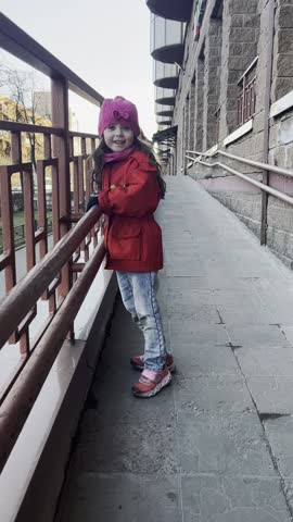 A little girl is playing outside