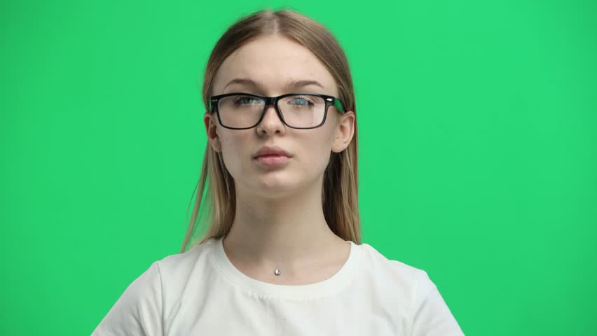 Woman, close-up, on a green background, wearing glasses