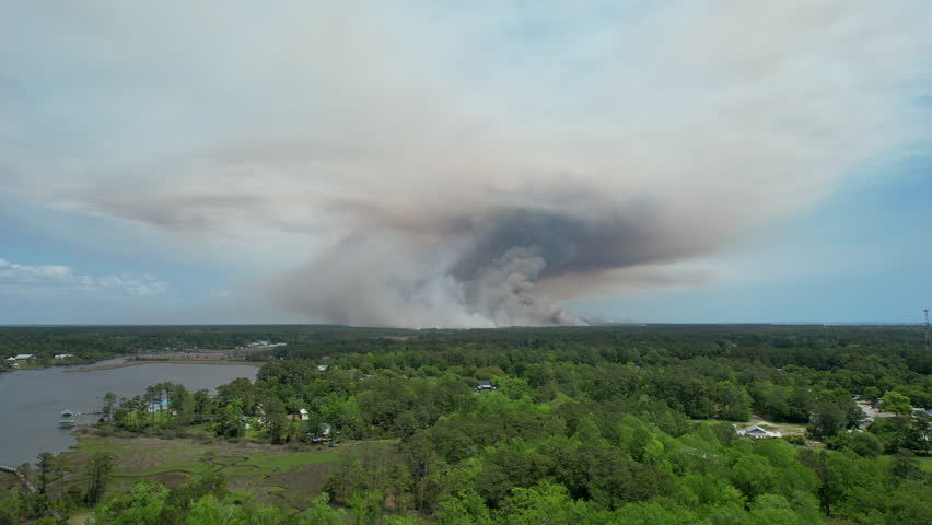 Wide drone shot of a forest fire.