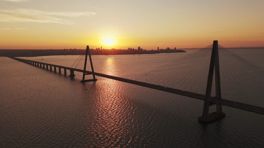 Drone flying over the San Roque González de Santa Cruz International Bridge at sunset. Argentina-Paraguay