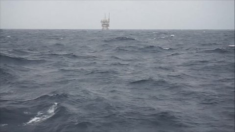 Anchor handling tug supply boat (AHTS) rolling during sailing on bad weather at South China Sea. 