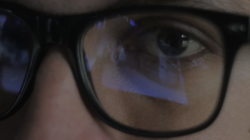 Close-up reflection in glasses: Gamer plays a video game on a computer in a dark room | Shutterstock HD Video #34982476
