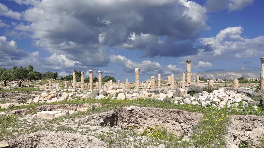 Roman ruins at Umm Qais (Umm Qays)--is a town in northern Jordan near the site of the ancient town of Gadara, Jordan. Against the background of a beautiful sky with clouds, 4K, time lapse, with zoom 