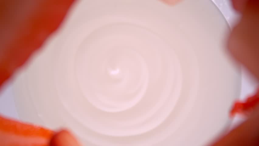 Super Slow Motion Shot of Fresh Strawberries Followed by Camera Falling into Yogurt at 1000fps.