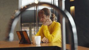 4K Asian Generation Z woman freelancer working business freelance job on digital tablet with using AI browsing data in coffee shop. Young woman working outside office on laptop with online network. - Powered by Shutterstock - Get 15% off with code: PIKWIZARD15