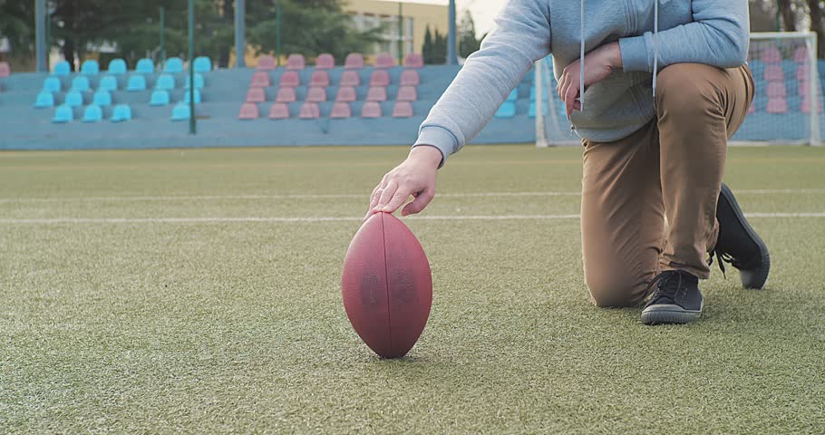 Father and son Playing Rugby Ball Outdoors, Dad Teaching the Boy to Play American Football. Family sports weekend, summer activities 4K video.