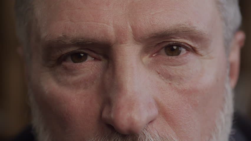 Intense Close-up of Senior Man Eyes with Eyebrow Raised in Surprise