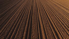Plowed farmland soil from drone pov, aerial shot, high angle view - Powered by Shutterstock - Get 15% off with code: PIKWIZARD15