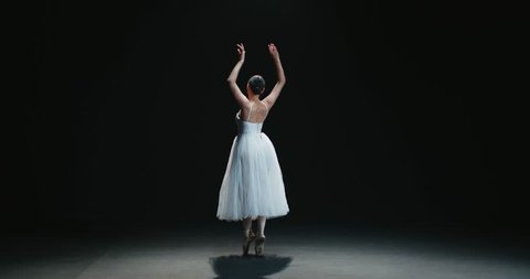 beautiful Asian girl ballet dancer dancing on black background slow motion