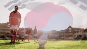 Animation of flag of korea over diverse male rugby players. Global sport, patriotism and digital interface concept digitally generated video.