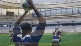 Animation of flag of uruguay over african american rugby player thowing ball to team at stadium. Uruguayan, nationality, team, sport and competition, digitally generated video. - Powered by Shutterstock - Get 15% off with code: PIKWIZARD15
