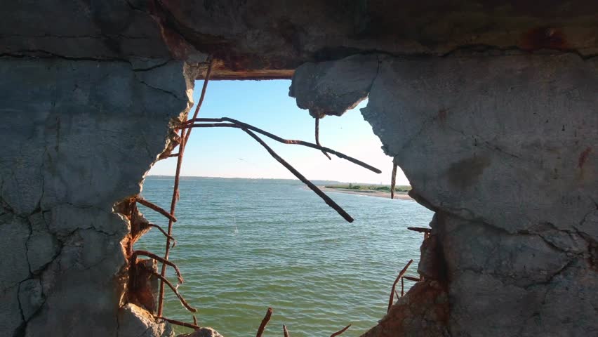 View of the Kinburn Spit through a hole in the side of an old abandoned barge that ran aground on the edge of the spit.