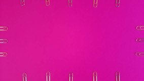 Paper clips Frame on pink background. Stop motion template with copy space in the center. Study time or business time animation with effect of attracting attention to message.